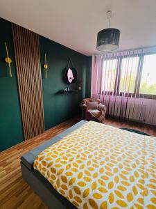 a bedroom with a large bed and a chair at Apartament Gossip XOXO in Galaţi +14 photos