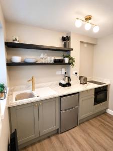 a kitchen with a sink and a counter at Central Apartments Cannock in Cannock