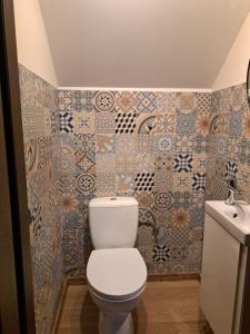 a bathroom with a toilet and a sink at Leśna przystań in Trupel +14 photos
