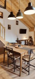 a dining room with a wooden table and chairs at Il borghetto di Lele & Schina in Arvier