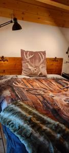 a bedroom with a bed with a deer pillow at Il borghetto di Lele & Schina in Arvier