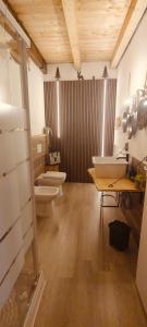 a bathroom with two sinks and two toilets in it at Il borghetto di Lele & Schina in Arvier +41 photos