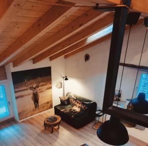 a living room with a large painting on the wall at Il borghetto di Lele & Schina in Arvier