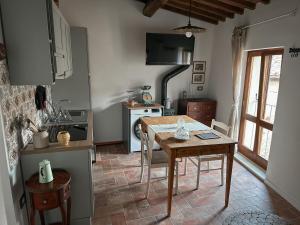 a kitchen with a wooden table and a table and chairs at C'era una volta in Abbadia San Salvatore