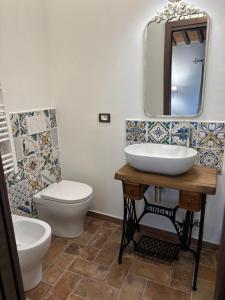 a bathroom with a sink and a toilet and a mirror at C'era una volta in Abbadia San Salvatore +21 photos