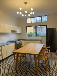a kitchen with a wooden table and chairs at Rio amazonas 7 in Mexico City