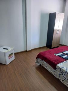 a room with a bed and a box in it at Hotel Status in Jaguarão +1 photo