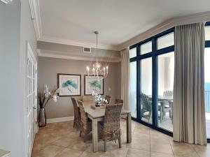a dining room with a table and some chairs at The Oasis Orange Beach 2110 in Orange Beach