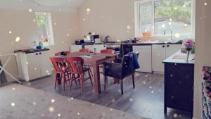a kitchen with a wooden table and chairs in it at Grove Stables in Kirk Leavington