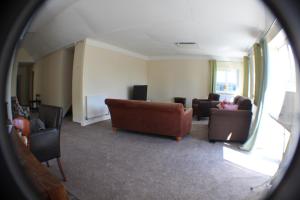 a view of a living room with couches and chairs at Grove Stables in Kirk Leavington