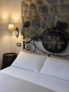 a bedroom with a bed with a stone wall at C'era una volta in Abbadia San Salvatore