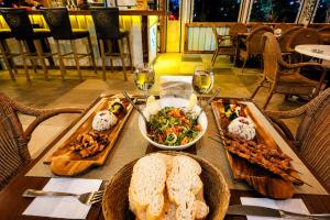 a table with food and glasses of wine at Fii Suites in Kumluca