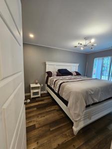 a bedroom with a white bed and a window at For-Rest Inn and Spa in Bathurst