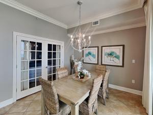 a dining room with a wooden table and chairs at The Oasis Orange Beach 2110 in Orange Beach