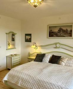 a bedroom with a large bed and a night stand at Mauthnerhube Ferienwohnung mit Sauna, Whirlpool, Hüttenfeeling in Sankt Oswald ob Eibiswald