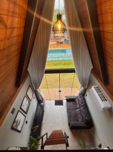 an overhead view of a living room with a large window at Hop Village in Praia do Rosa