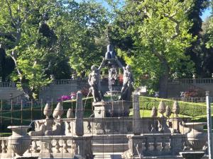 a fountain with two statues on top of it at Alloggio turistico borgo antico in Bagnaia +4 photos