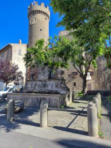 a building with a tower with a clock on it at Alloggio turistico borgo antico in Bagnaia