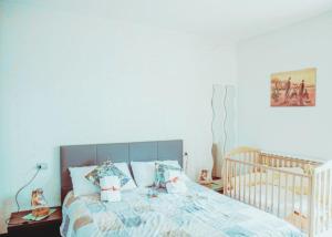a bedroom with a bed and a crib in it at Via della Musica in Vicchio