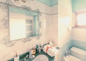 a bathroom with a sink and a mirror and a toilet at Via della Musica in Vicchio +20 photos