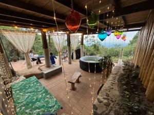 a patio with a hot tub and hanging lights at Lunanueva in Cali