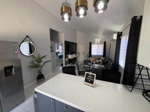 a kitchen and living room with a white counter top at The Perrys Chateau in Old Harbour