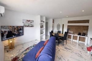 a living room with a blue couch and a table at T3 moderne - Clim - Parking privé 4 couchages in Decazeville