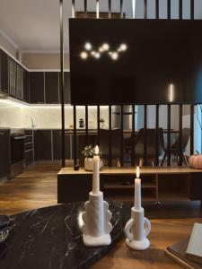 two candles sitting on a table in a living room at Stay Central 2 in Ioannina