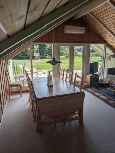 a dining room with a large wooden table and chairs at Marielyst Summer House in Bøtø By
