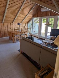 a living room with a couch and a table at Marielyst Summer House in Bøtø By