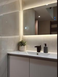 a bathroom with a sink and a mirror at Stay Central 2 in Ioannina +27 photos