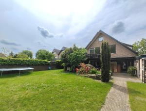 a house with a grass yard in front of it at VolopVeluwe in Ermelo +32 photos