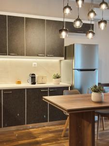a kitchen with a wooden table and a blue refrigerator at Stay Central 2 in Ioannina