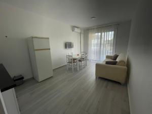 a living room with a couch and a table at Golem Apartments in Golem +12 photos
