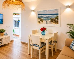 a dining room with a table and chairs at DUNA - Escapada romántica en Punta Paloma in Tarifa