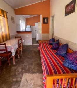 a living room with a bed and a table at Pouso do Elefante in Serra do Cipo