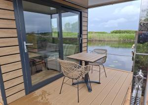 a patio with a table and chairs on a deck at Aquastay Drift in Athlone