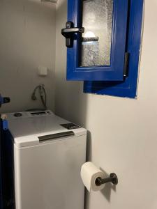 a bathroom with a blue cabinet and a white refrigerator at Vorino house in Amorgos +19 photos