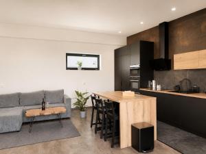 a kitchen and living room with a couch and a table at Apartmán Natalka7 in Bartovice