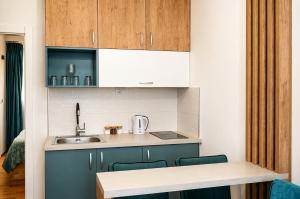 a kitchen with blue cabinets and a sink at Apartments NOCE - Premium Lake View in Ohrid
