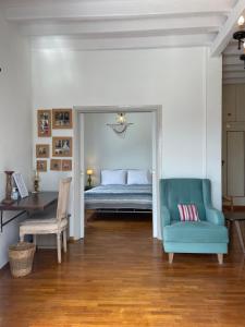a bedroom with a bed and a chair and a table at Vorino house in Amorgos