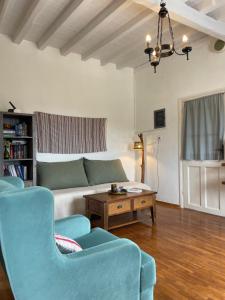a living room with blue chairs and a couch at Vorino house in Amorgos