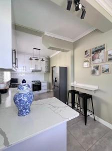 a kitchen with a vase sitting on a counter at Heaven on Windermere in Durban