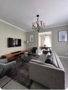 a living room with a couch and a tv at Heaven on Windermere in Durban