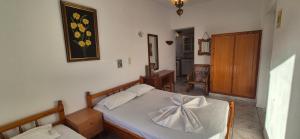 a bedroom with a bed with a bow on it at Mary's House in Vourliótai +40 photos