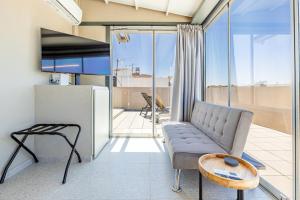 a living room with a couch and a table at Raise Porta Nuova in Heraklio