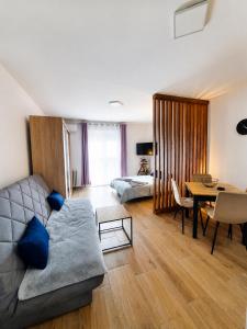 a living room with a couch and a table at Apartman Nati in Banja Koviljača