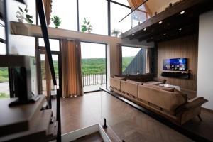 a living room with a large couch and a tv at Quba QubaLand in Qǝlǝduz