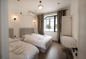 a hotel room with two beds and a window at Quba QubaLand in Qǝlǝduz +31 photos