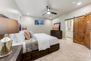 a bedroom with a bed and a table with a lamp at Chalet Near The Tahoe Keys in South Lake Tahoe